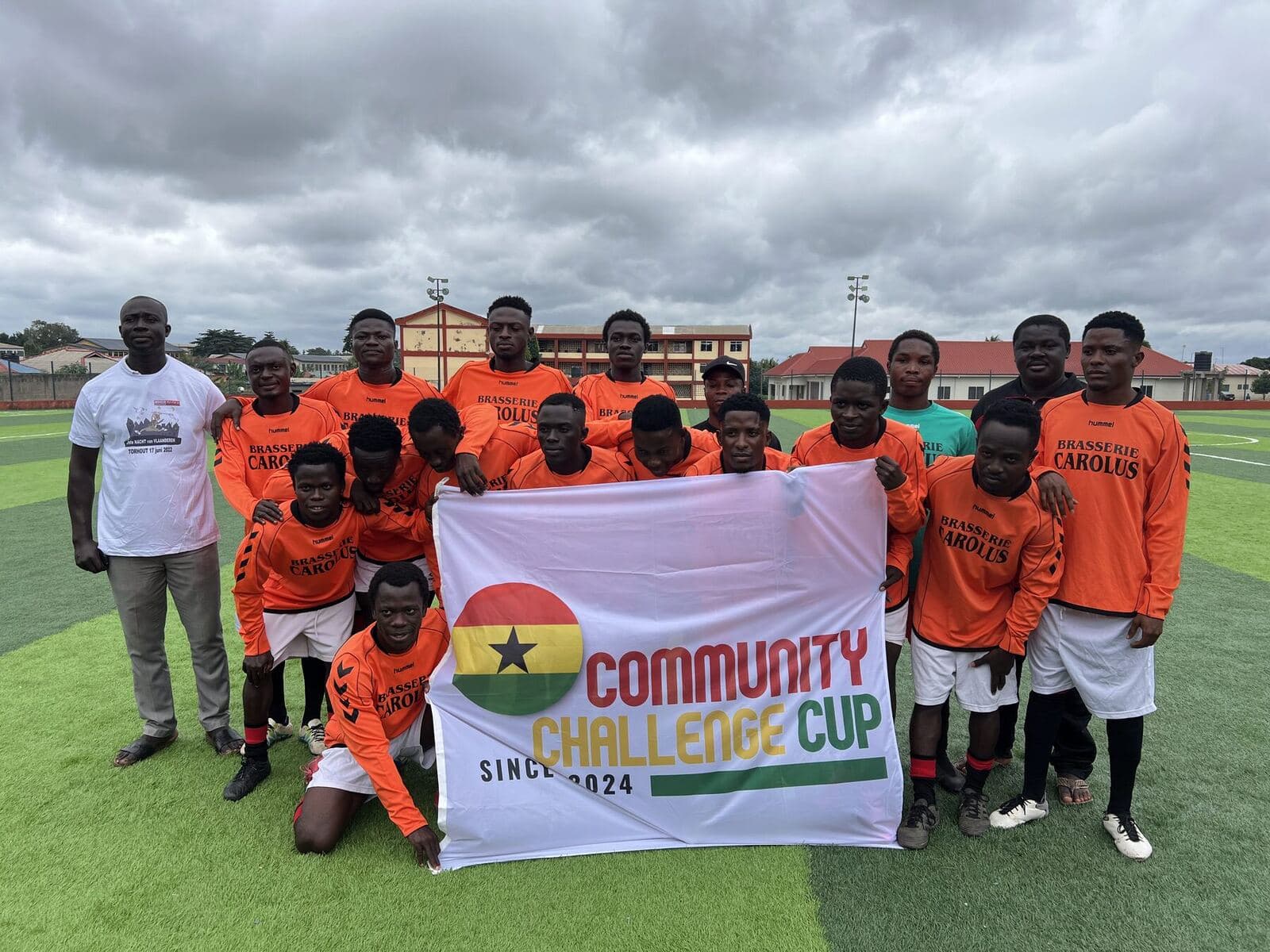 Team in orange with the Community Challenge Cup banner