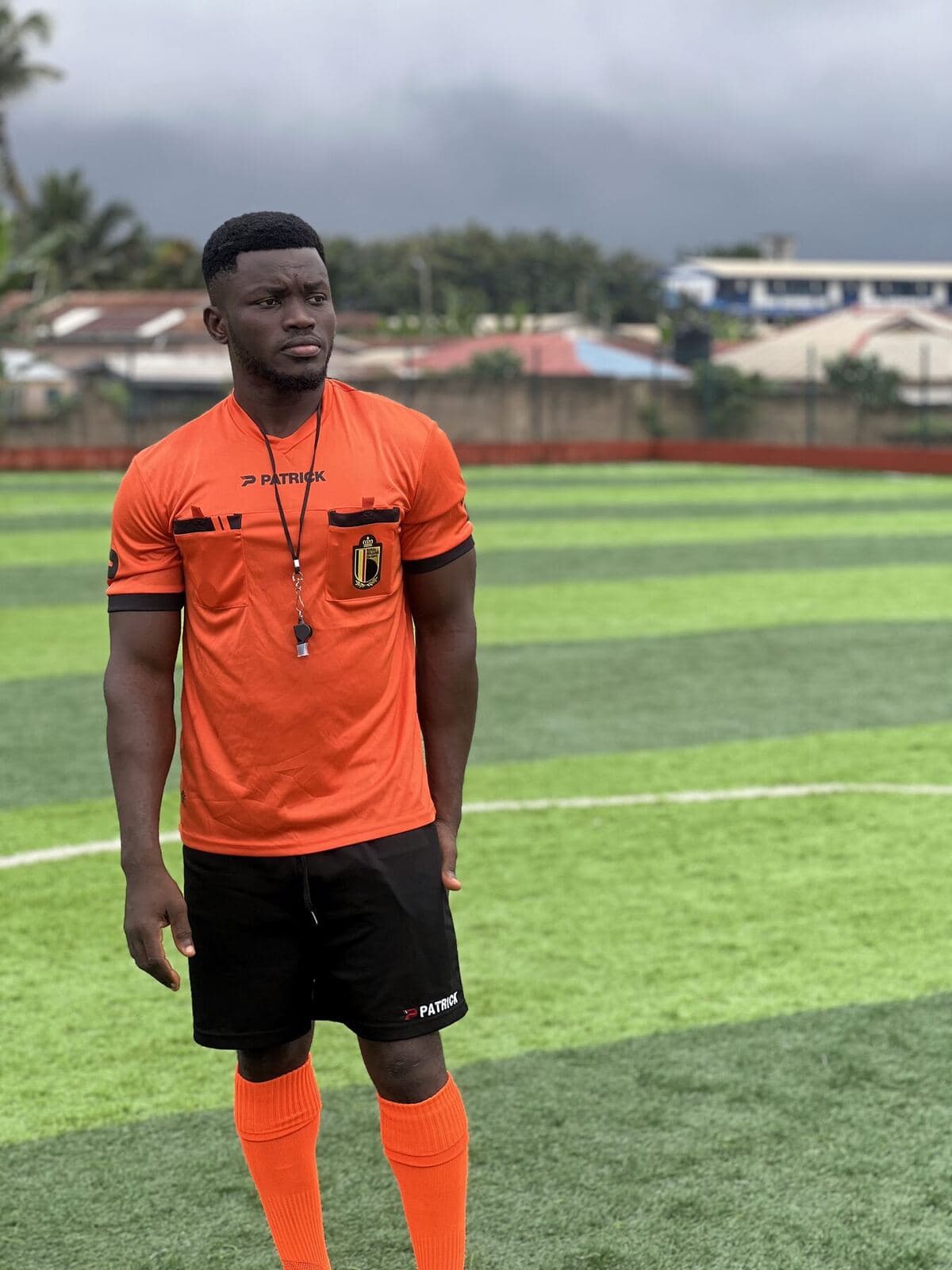 Referee in orange before the match
