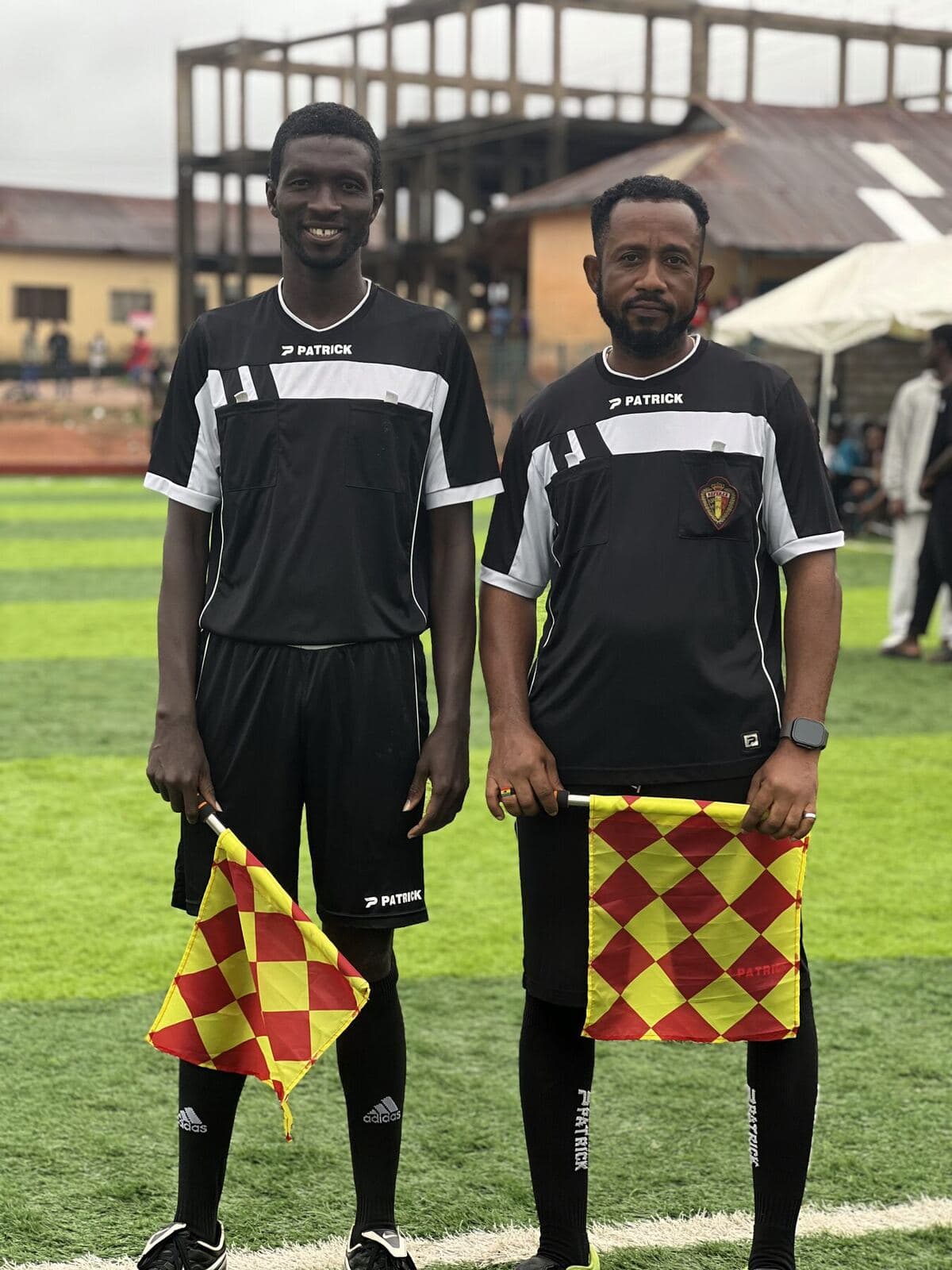 The two assistant referees with their flags