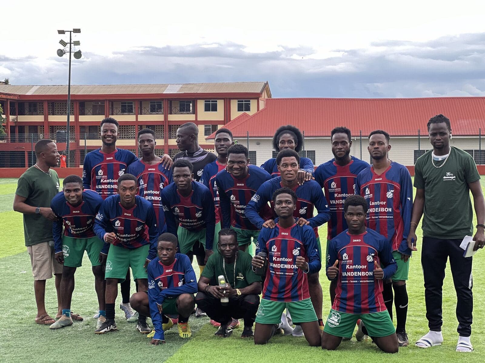 Team in red and blue stripes with their staff