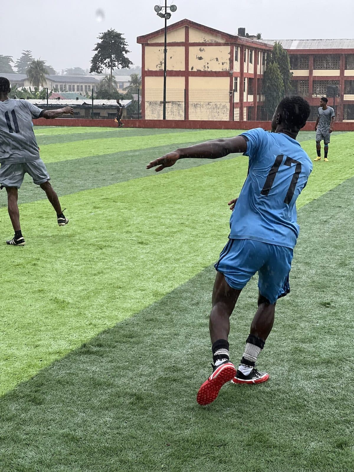 Player in light blue in action in the rain