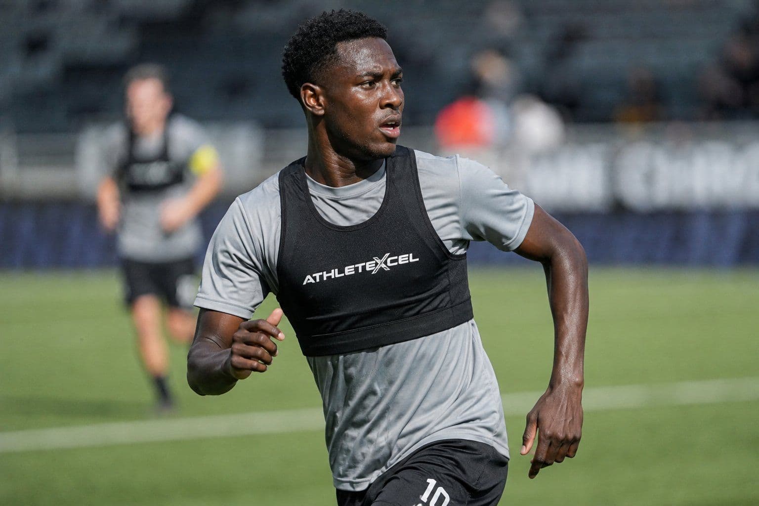 Player sprinting in an ATHLETE-XCEL GPS vest